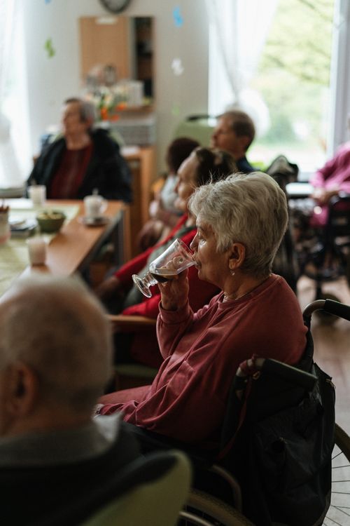 Free A cozy indoor gathering of elderly individuals enjoying coffee together. Stock Photo