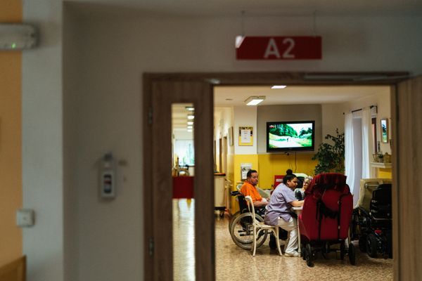 Home care professional assisting patient