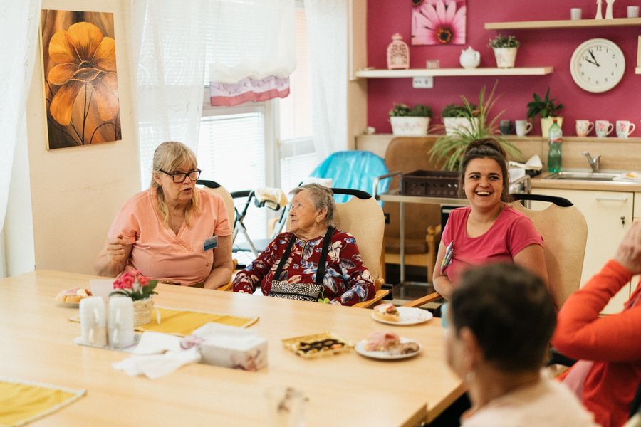 Seniors and caregivers dining together