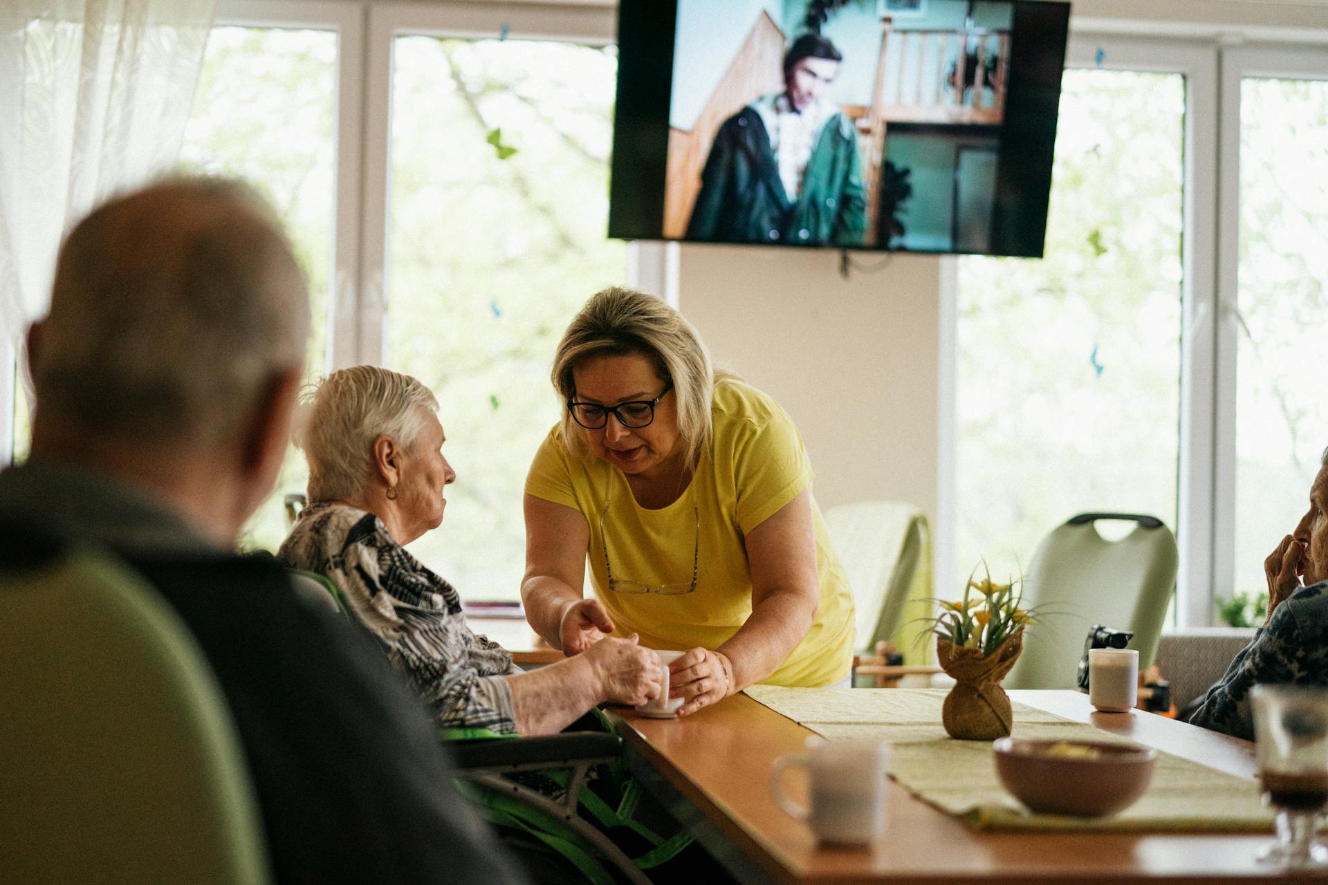 Blonde Woman Taking Care of Seniors