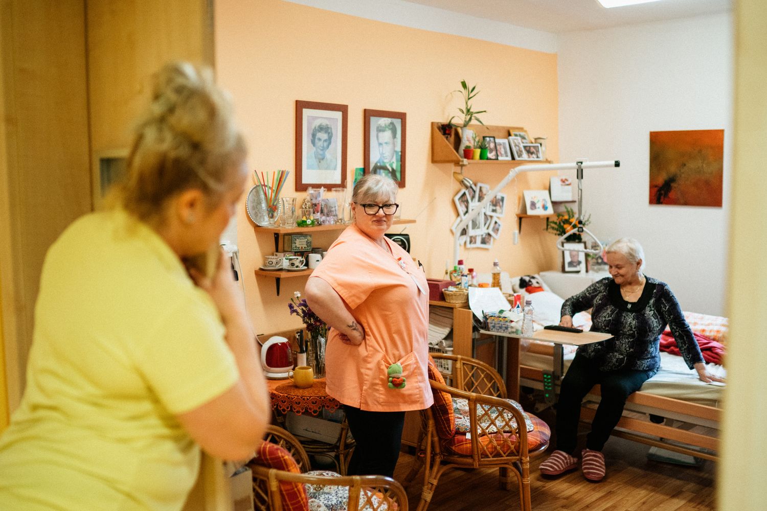 Caregiver warmly interacting with a resident in a comfortable care setting