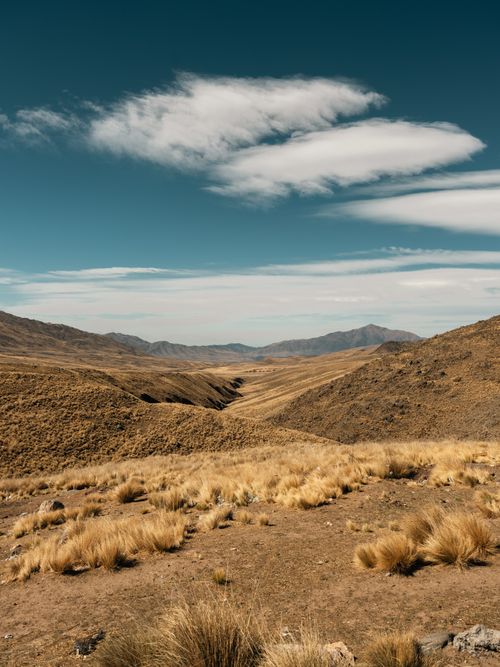 Free Breathtaking landscape shot capturing the dry, rugged hills of Cafayate, Argentina under a clear blue sky. Stock Photo