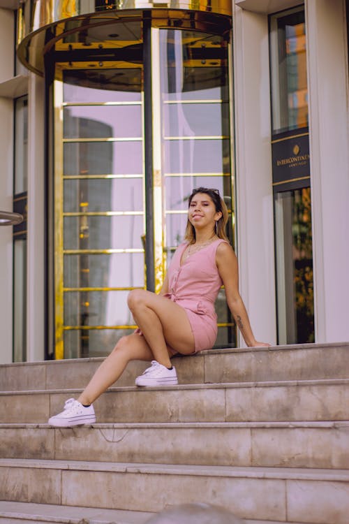 Woman Wearing Pink Dress Sitting on Stairs