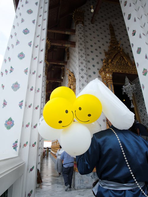 Person with Balloons at Temple