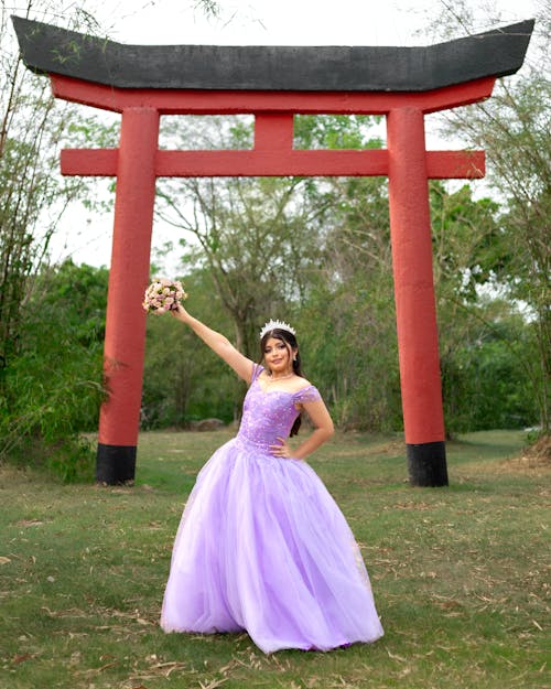 Young Woman in Purple Dress Posing by Torii Gate