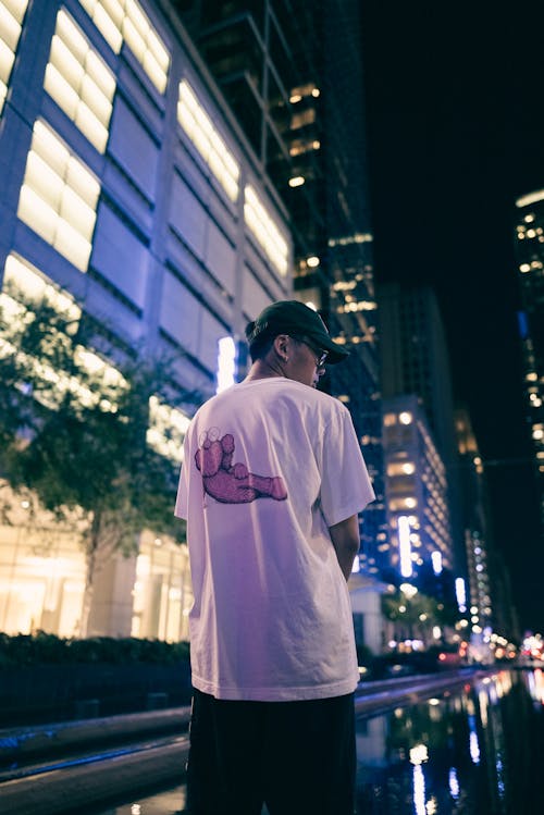 Man in T-shirt in City at Night