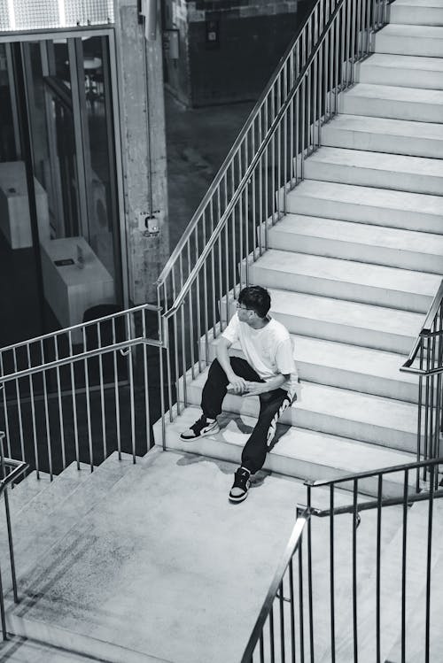 A Person Sitting on a Staircase