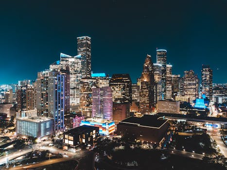 Stunning illuminated skyline capturing the essence of urban nightlife. Bright skyscrapers light up the night.