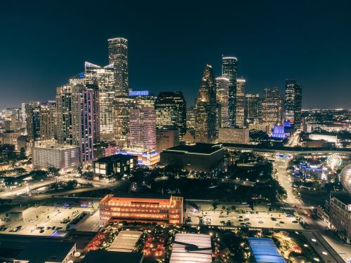 Free Stunning aerial view of a city skyline illuminated at night, showcasing modern architecture. Stock Photo