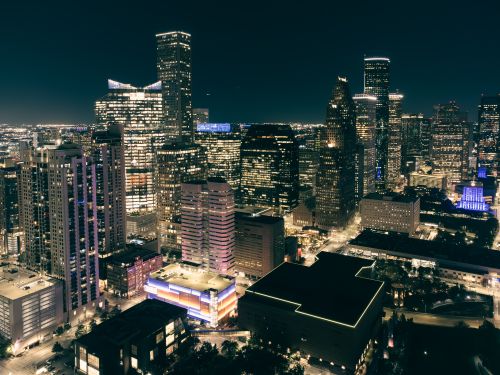 Free Illuminated cityscape showcasing a vibrant urban skyline at night with skyscrapers. Stock Photo