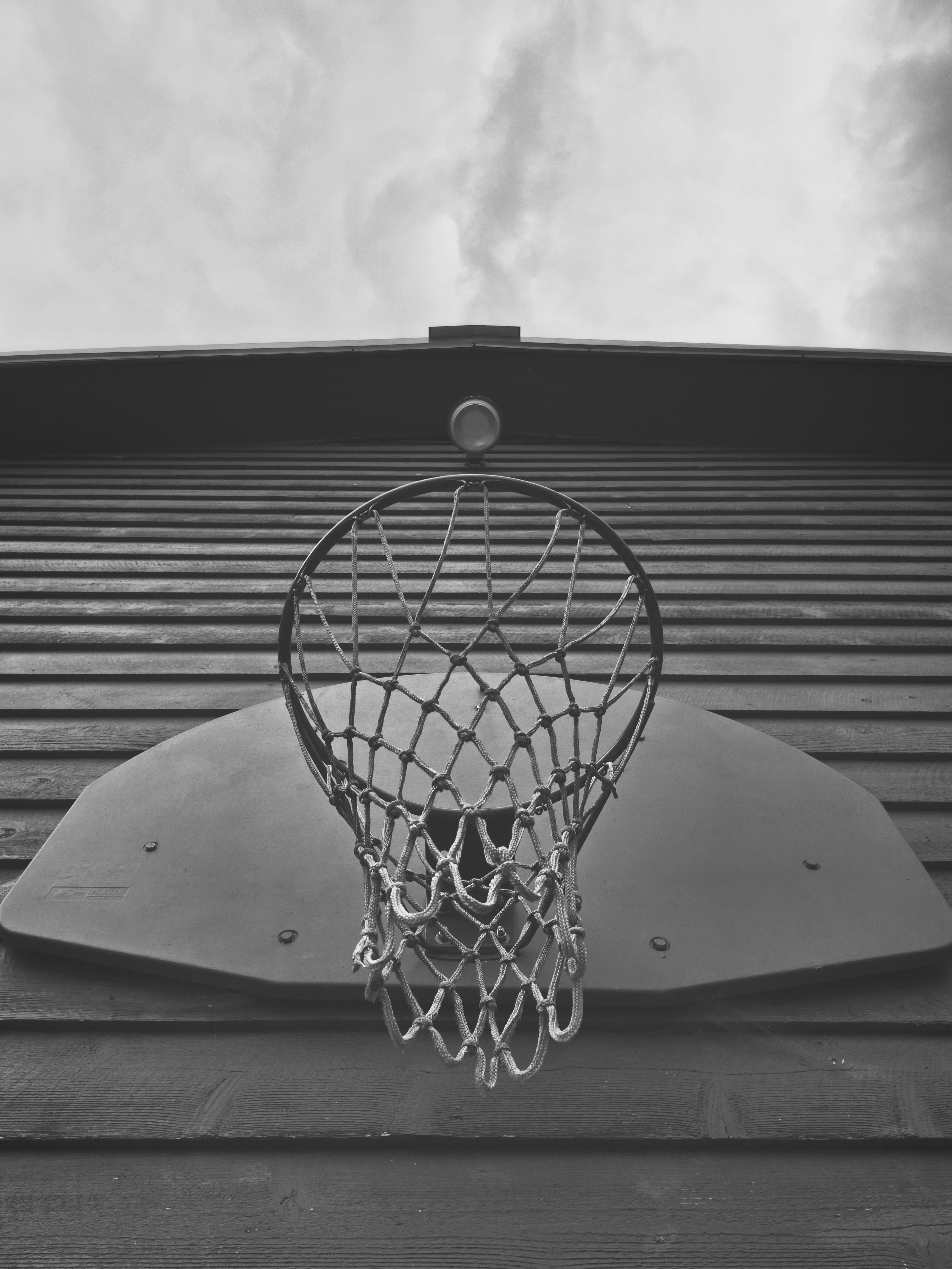 black and white photo of a basketball hoop on a wall