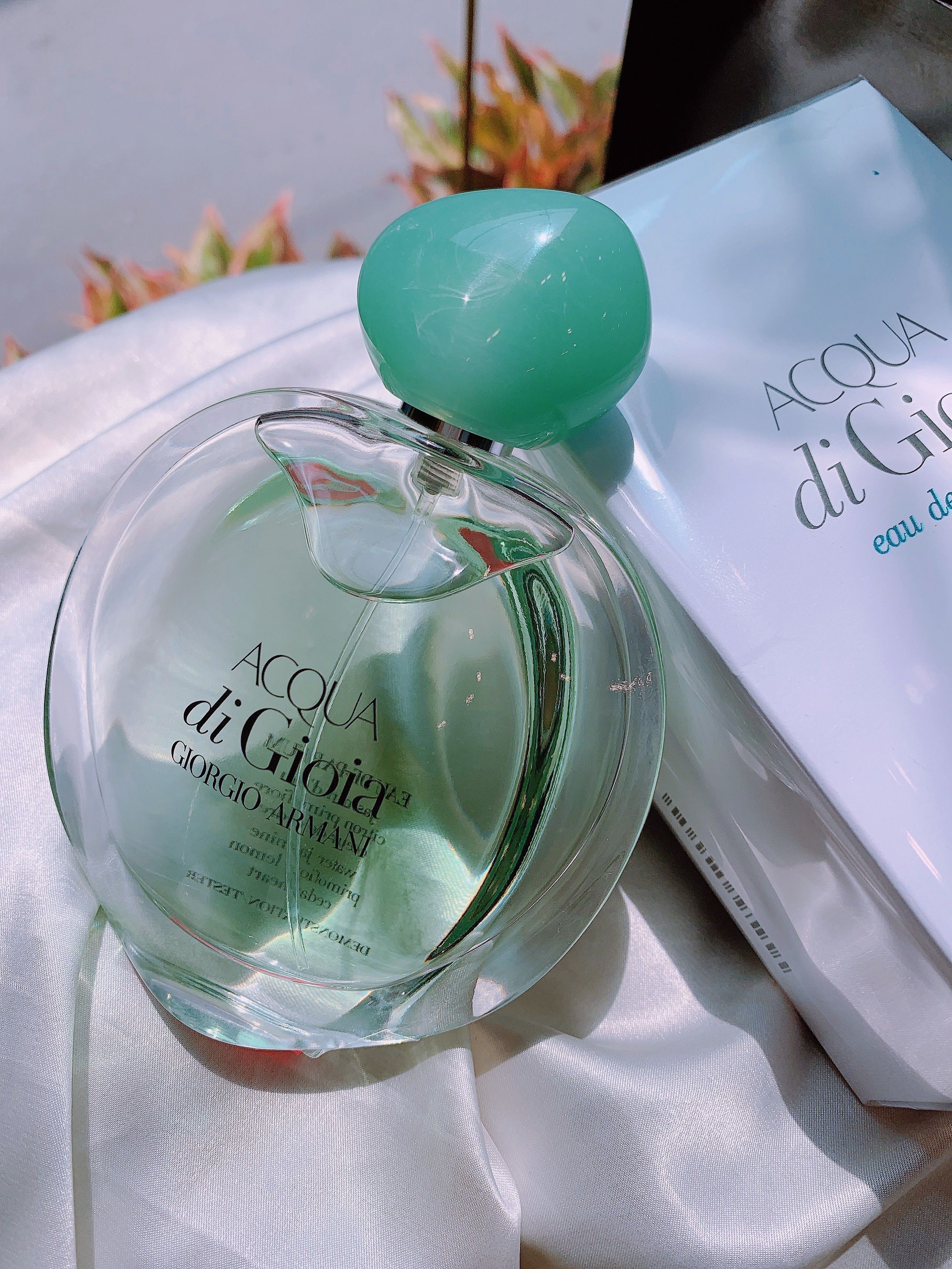 Elegant Giorgio Armani Acqua di Gioia perfume bottle displayed with delicate lighting.