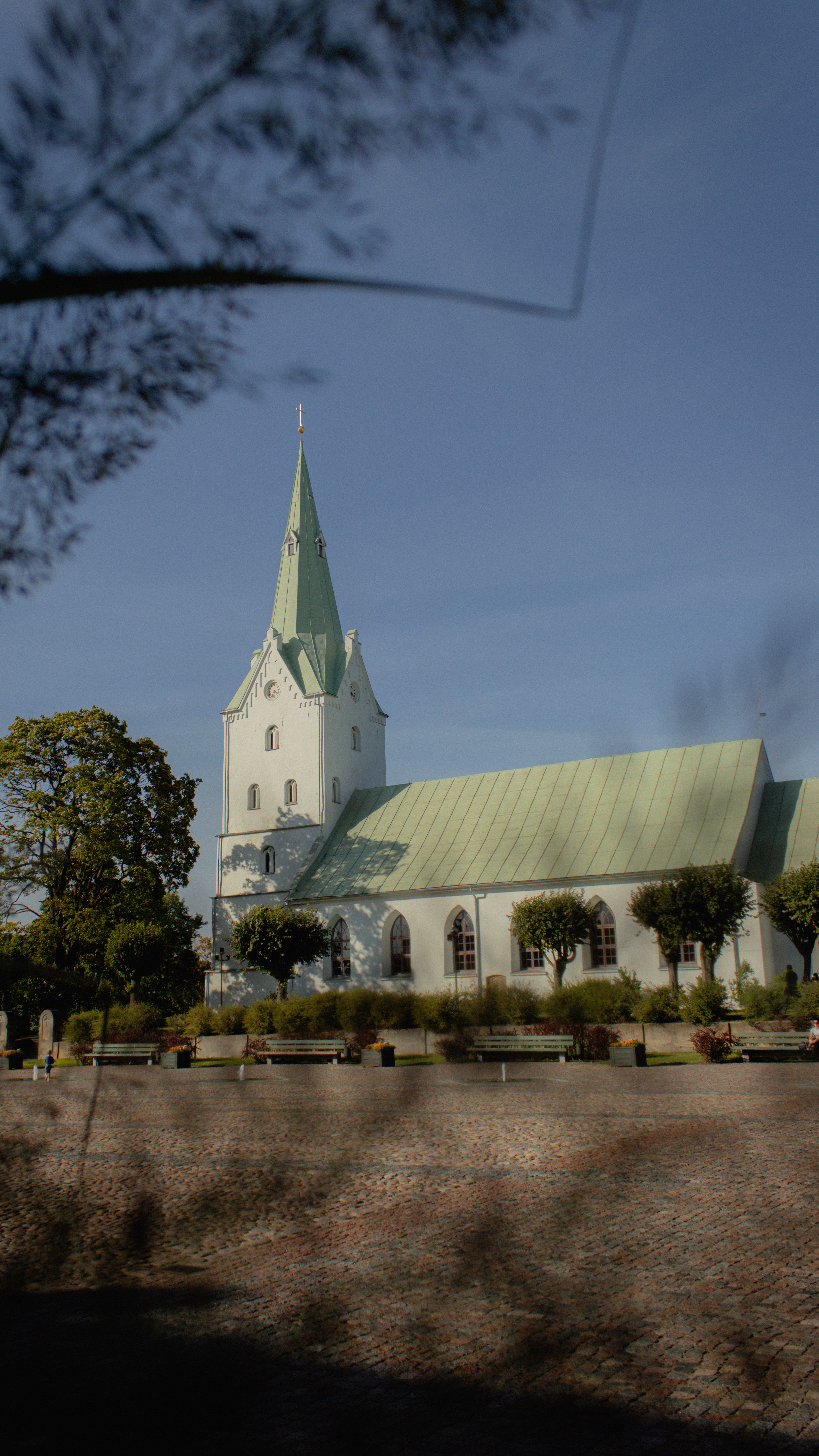 Beautiful view of an evangelical Lutheran church in Latvia with a distinctive green roof.