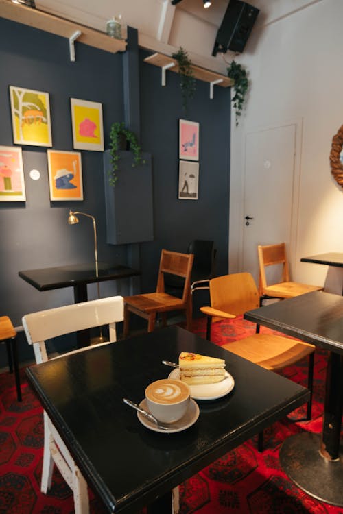 A Coffee and a Slice of Cake Standing on a Table in a Cafe