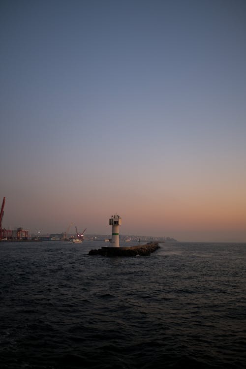 Free Lighthouse on the Breakwater in the Bosphorus Strait at Dusk Stock Photo