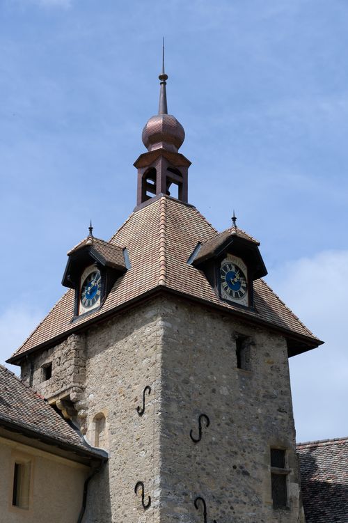 Free Medieval clock tower in Romainmôtier-Envy, Switzerland, showcasing historical architecture. Stock Photo