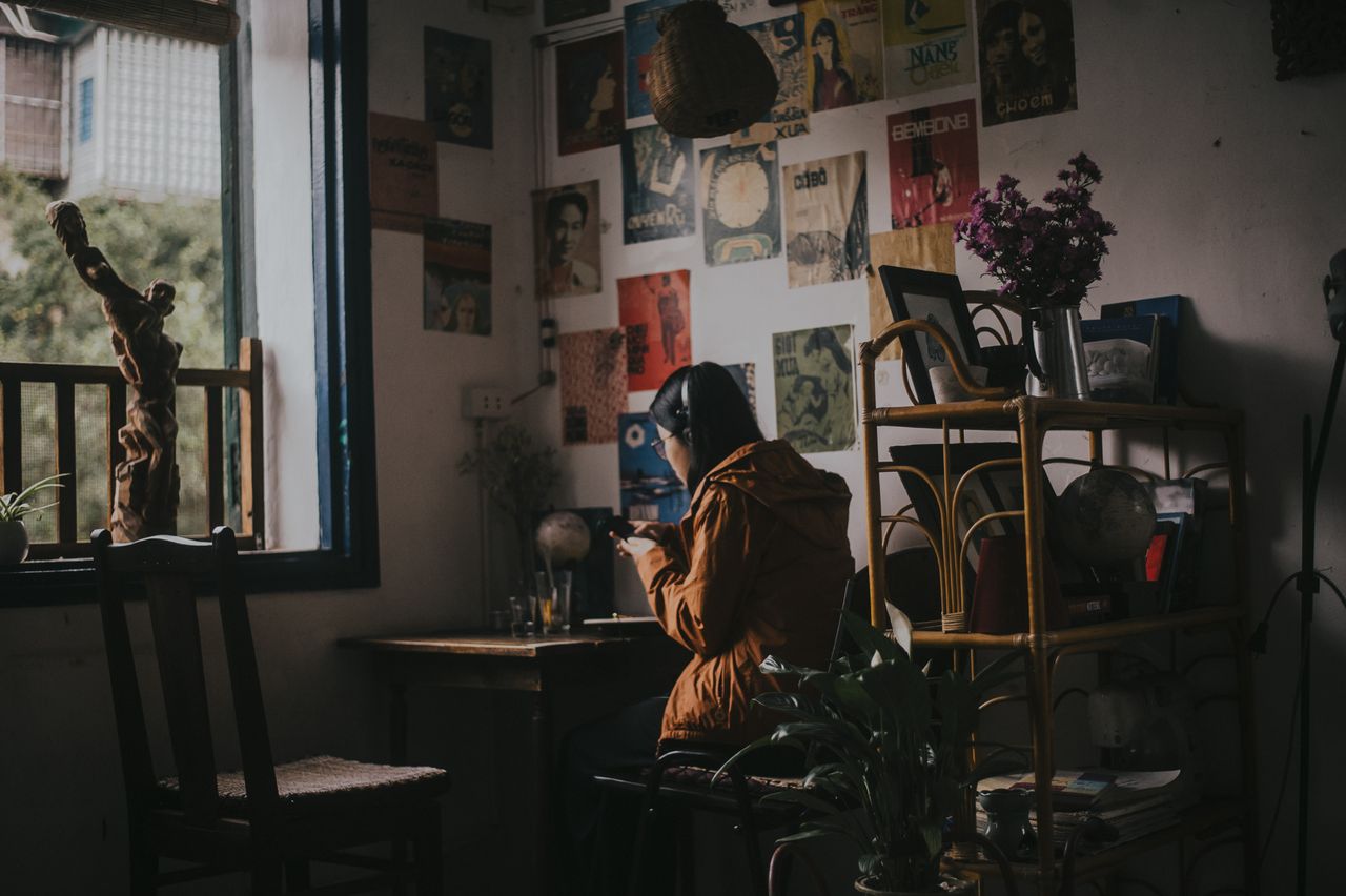 a person enjoys a relaxing moment in a cafe surrounded by art and natu
