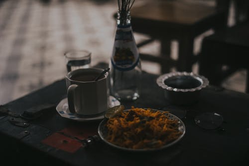 Cup Bottle and Food on Table Close-up Photo