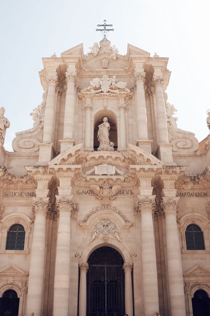 Stunning Baroque facade of Cathedral of Syracuse in Italy highlighting intricate architectural details.