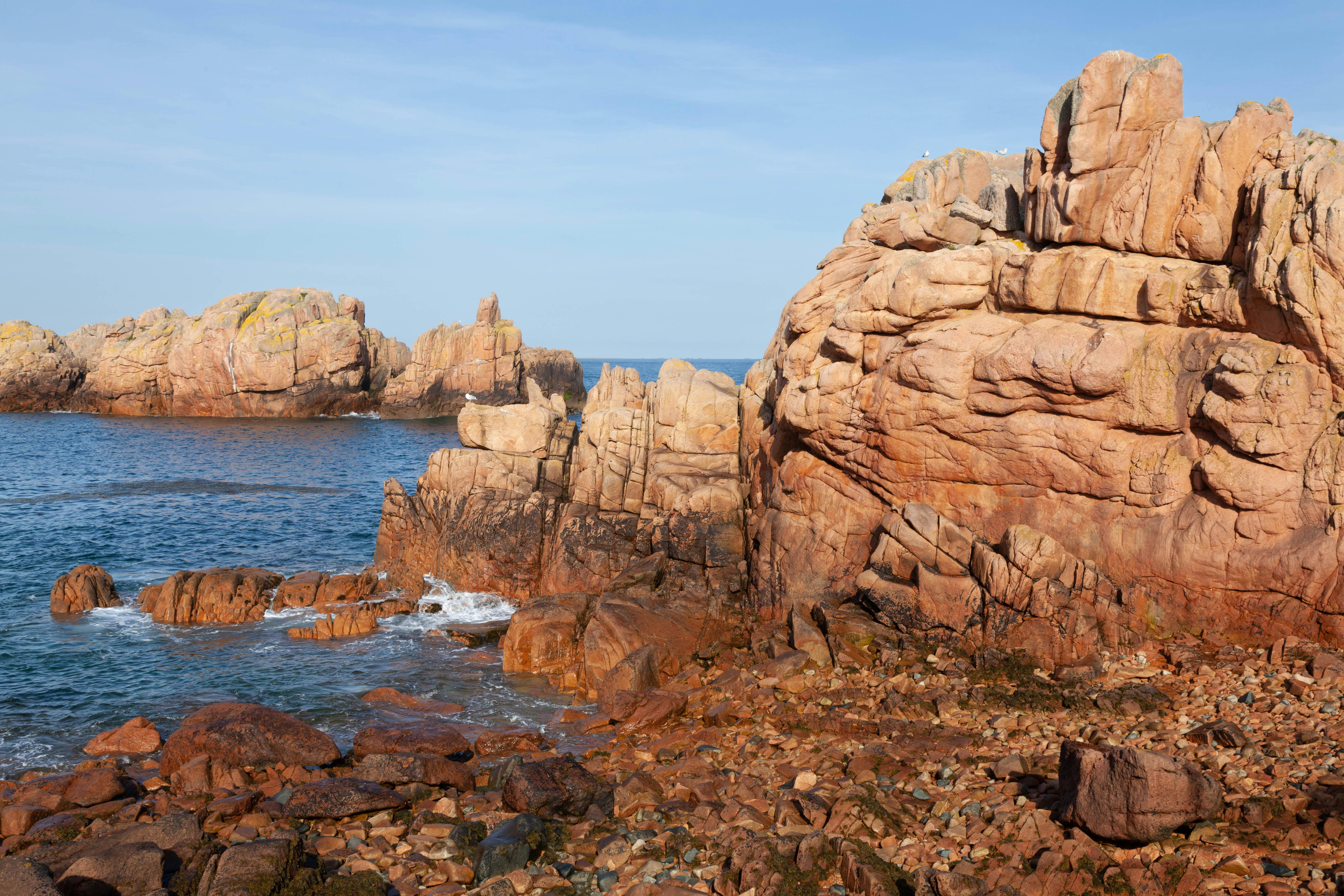 the rocky coastline of the ocean with some rocks