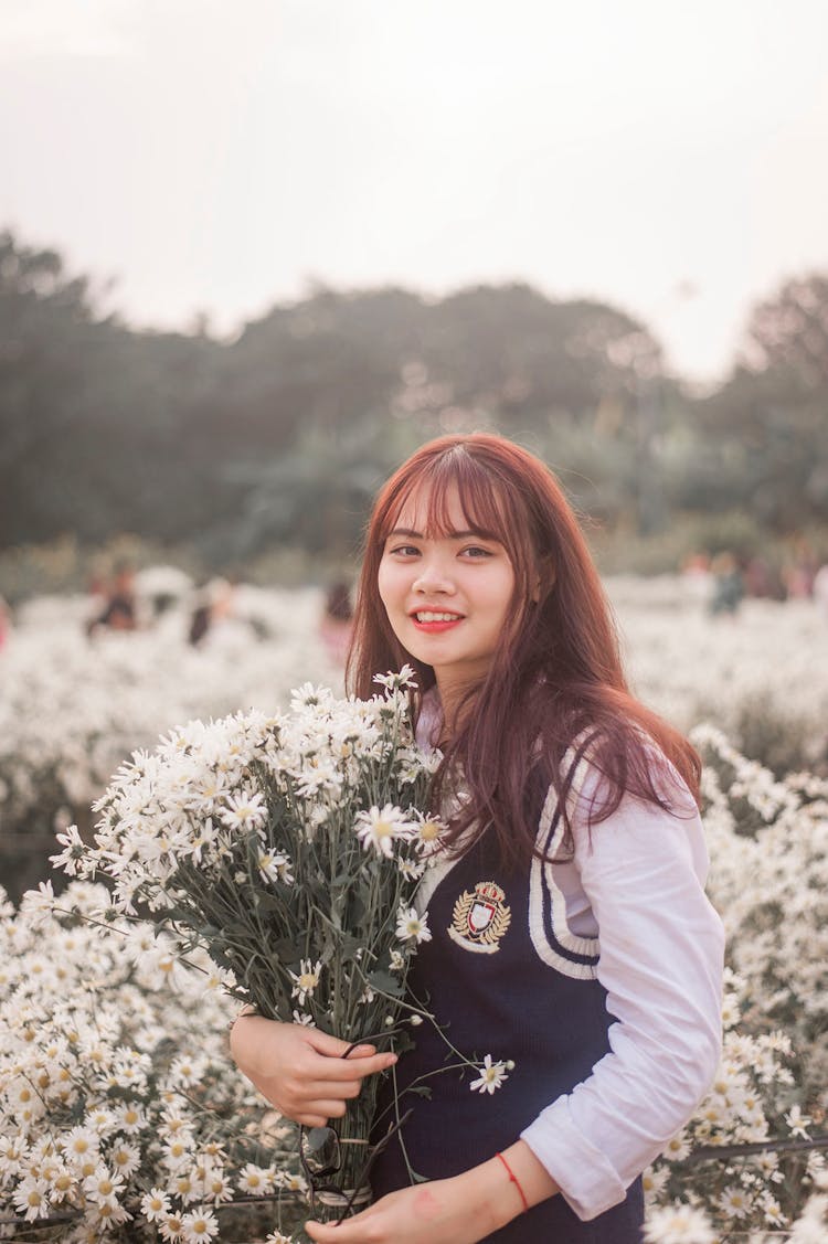 Photo Of Woman Holding Flowers