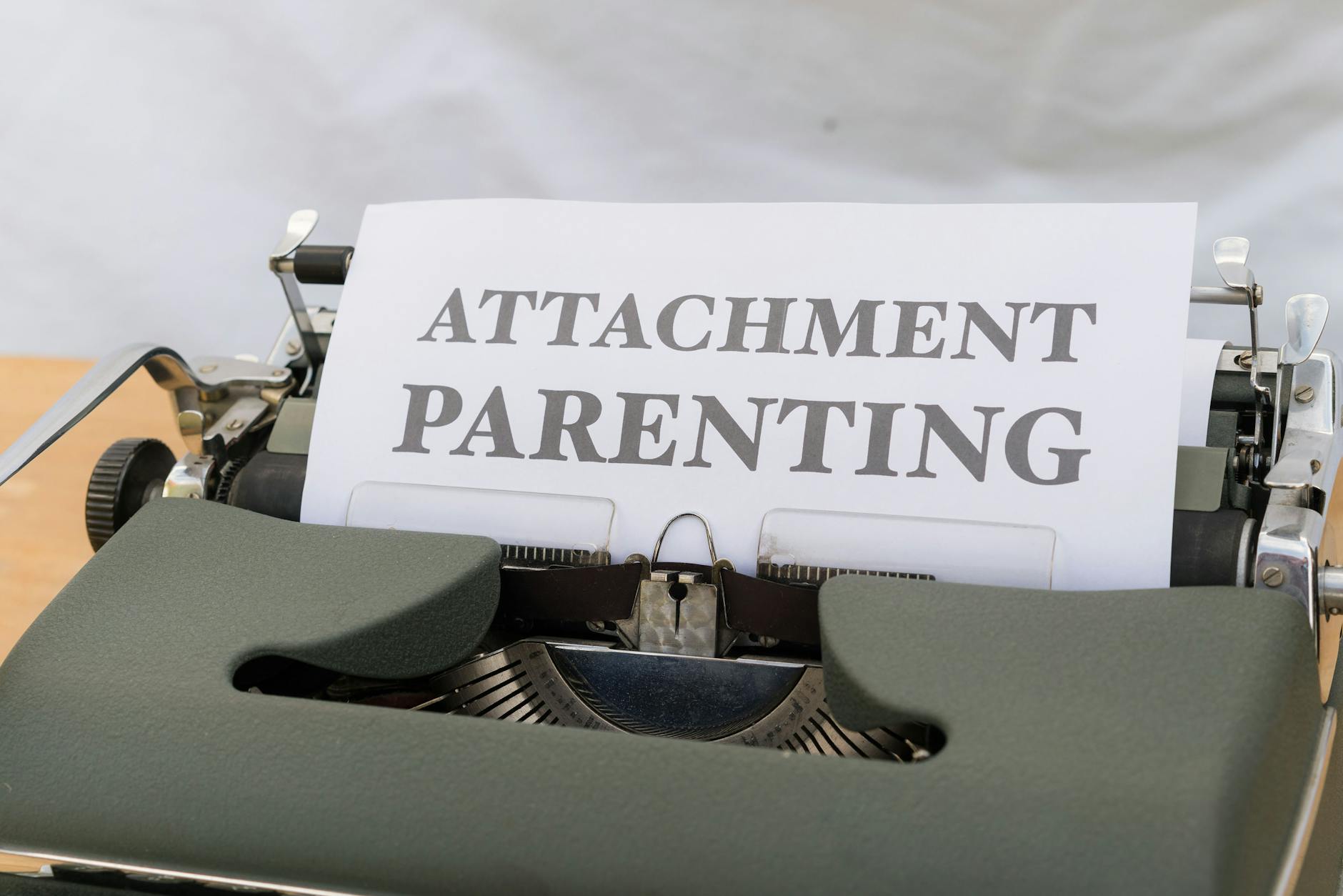 A typewriter with the words attachment parenting on it