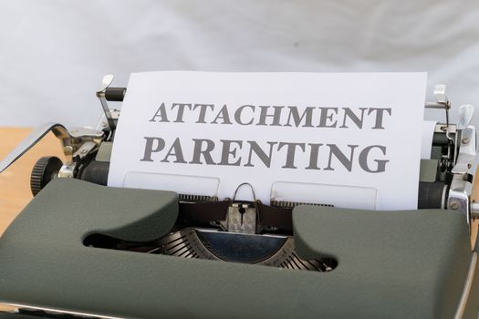 A typewriter with the words attachment parenting on it