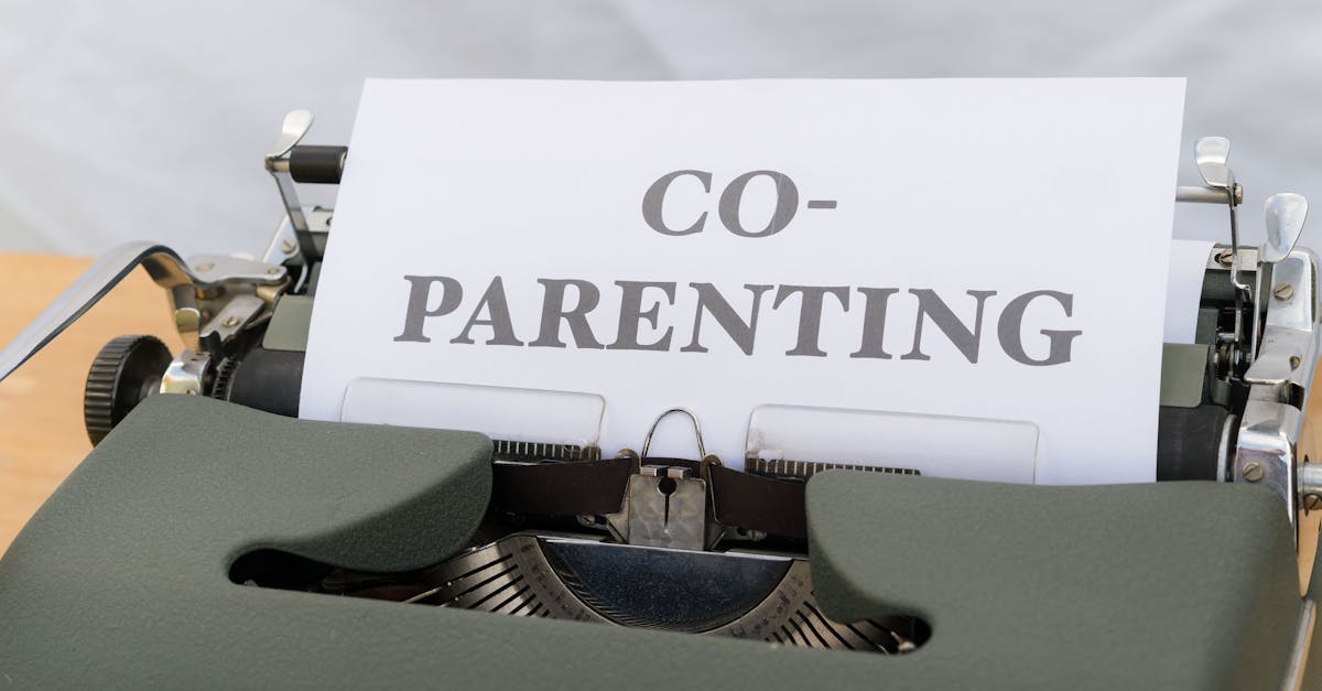 Two parents sitting together on a park bench, looking at documents and talking calmly.