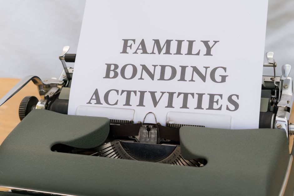 Close-up of a typewriter paper document titled 'Family Bonding Activities' showing retro typeface.