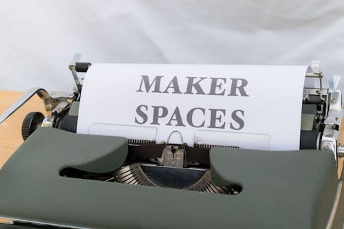 A typewriter with a paper that says maker spaces