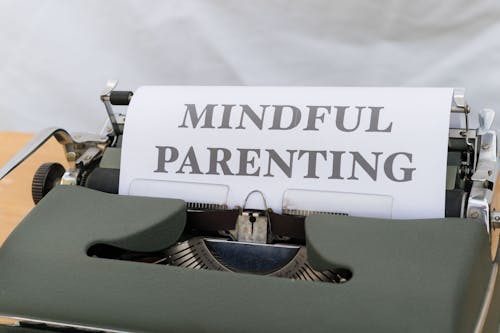 A typewriter with the words mindful parenting written on it