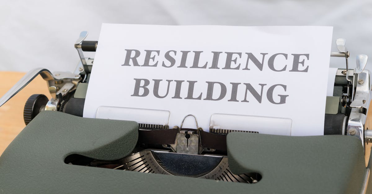 A typewriter with the word resilience building on it