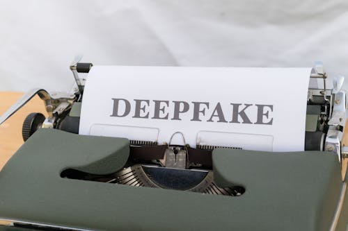 A typewriter with a paper that says deepfake