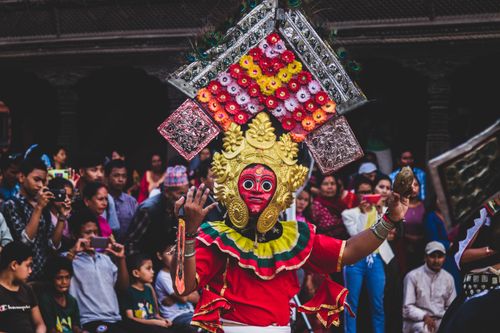 Free Colorful traditional masked dance performance in Bhaktapur, Nepal, captivating the audience during a vibrant festival. Stock Photo
