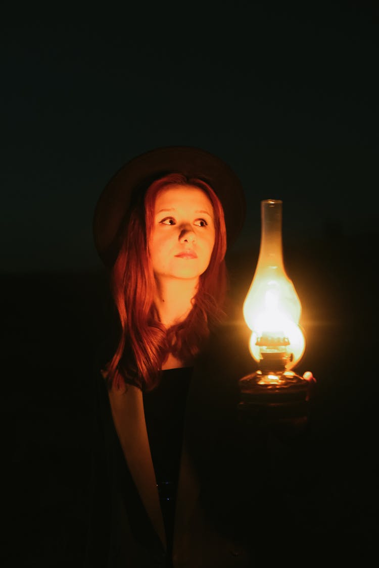 Woman With Vintage Lamp At Night