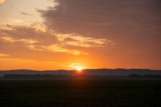Breathtaking sunset over rural fields in Kellogg, Minnesota with vibrant sky colors.
