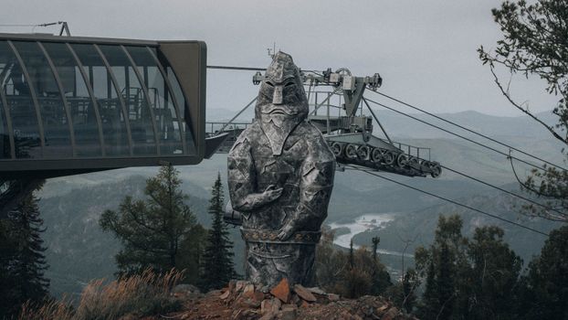 A statue of a man on top of a mountain