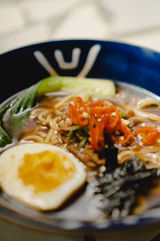 Savory ramen noodles with chili, egg, and vegetables in a rich broth, perfect for a warm meal.