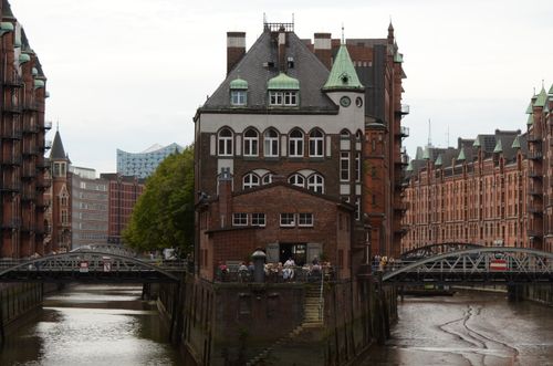 Free Captivating view of Hamburg's Speicherstadt, featuring iconic red brick warehouses along the canal. Stock Photo