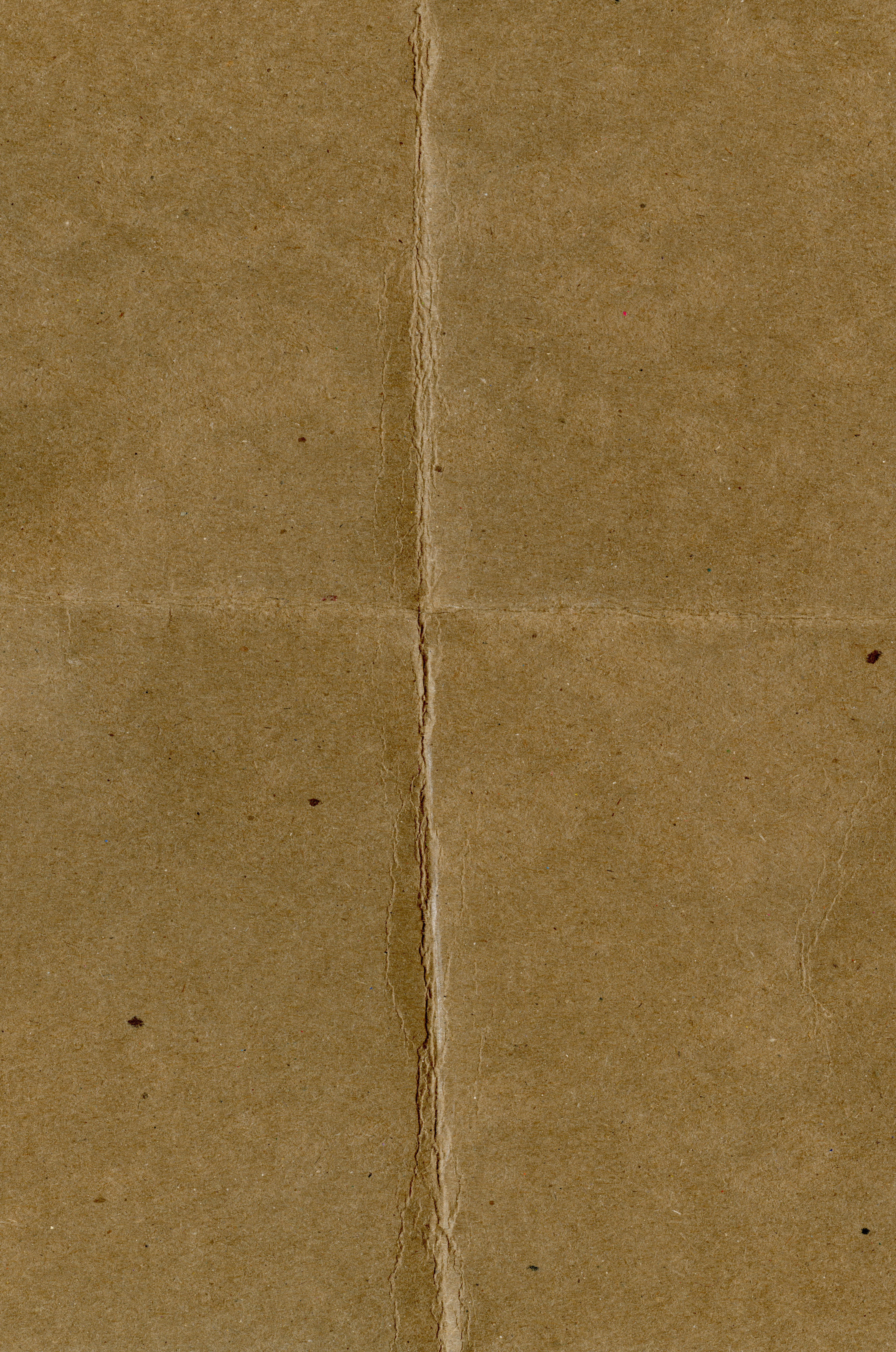 Free Close-up of an aged brown paper with central crease and subtle texture. Stock Photo
