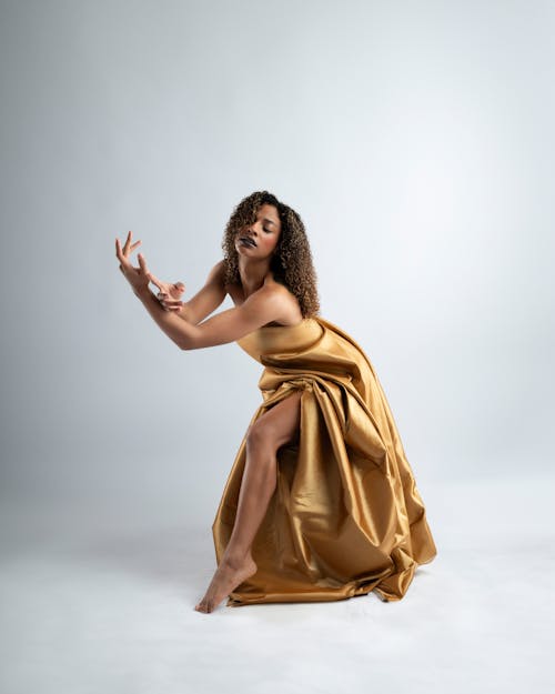 Model Posing in Gold Dress