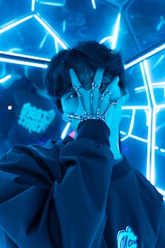 Stylish portrait of a young man surrounded by vibrant blue neon lights, creating a futuristic look.