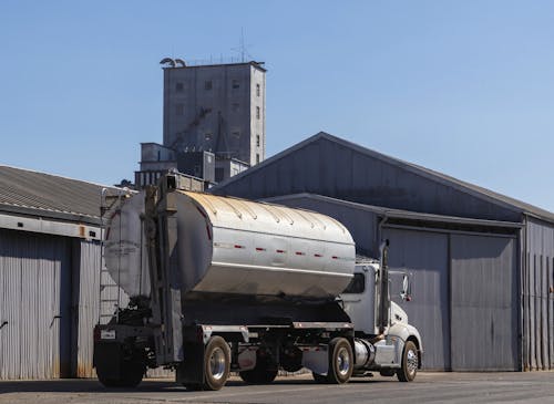Tanker for Transporting Grain Feed in Front of Warehouses
