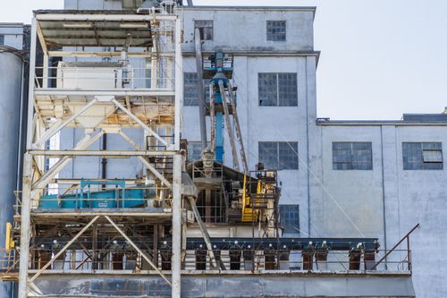 Free Industrial facility's exterior showcasing machinery and architectural structure for construction purposes. Stock Photo