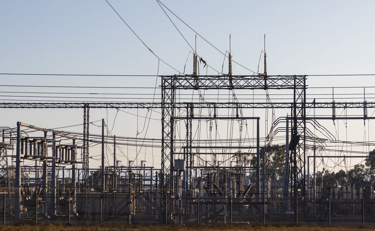 High-voltage electrical substation and transmission infrastructure at dawn