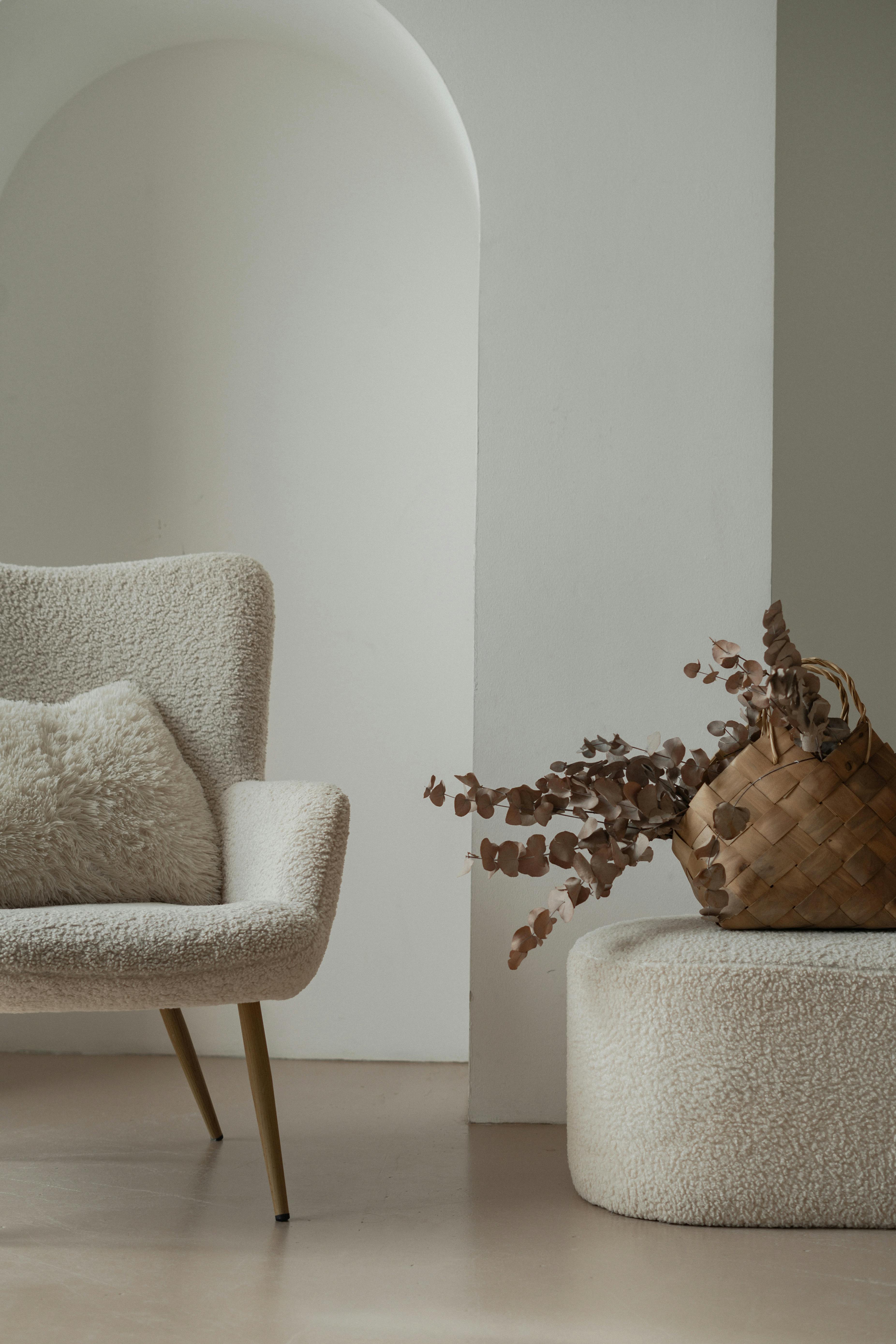 Elegant living room with plush chair and decorative elements in a modern style.