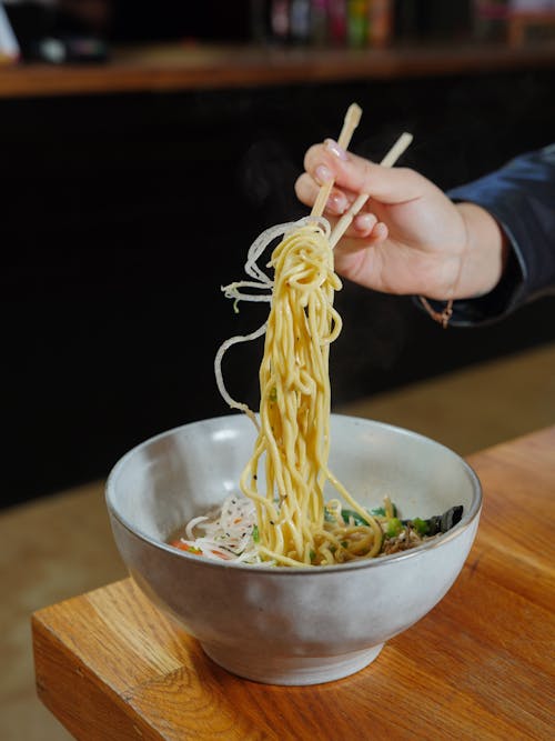 Free Person Eating Pasta with Chopsticks Stock Photo