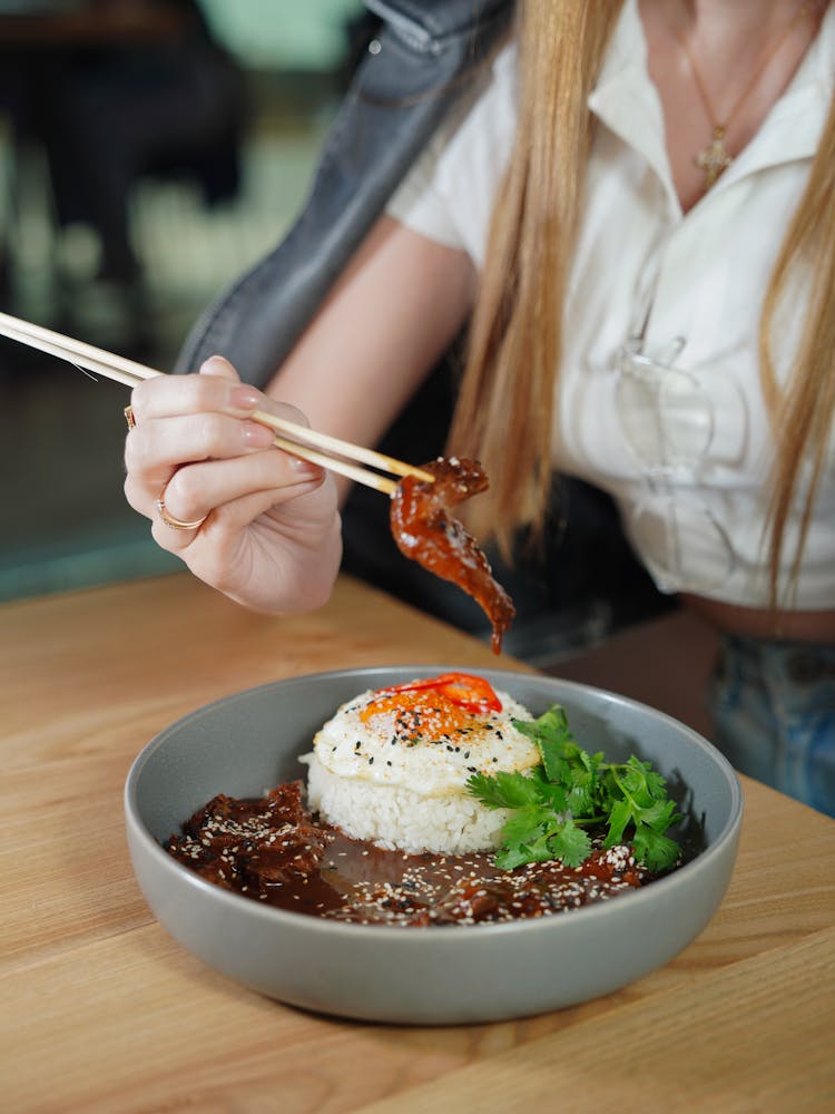 Woman Eating Lunch With Chopsticks