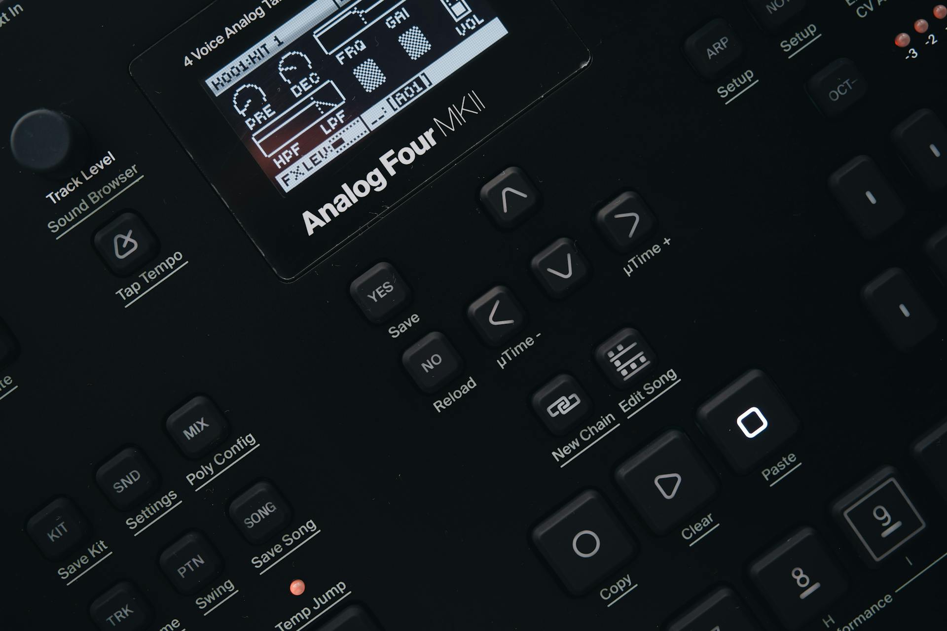 Detailed view of an Analog Four MKII synthesizer control panel, featuring buttons and screen.