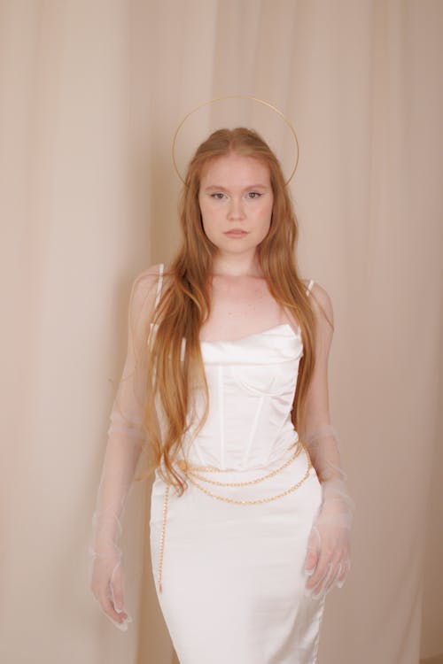 Person Posing in White Gown With Halo as Jewellry 